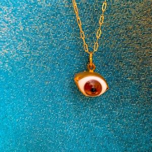 Eye pendant necklace. Glass eye bezel set in brass